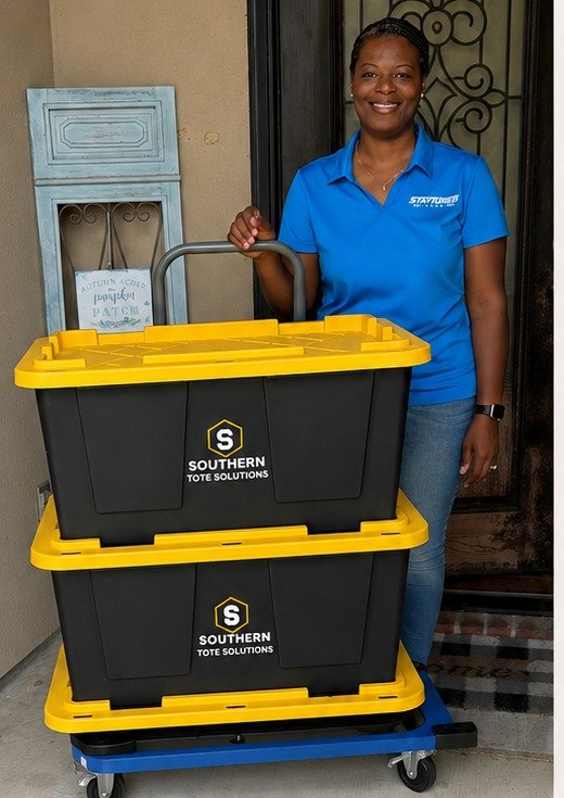 Southern Tote Solutions team member delivering a stack of rental totes on a dolly
